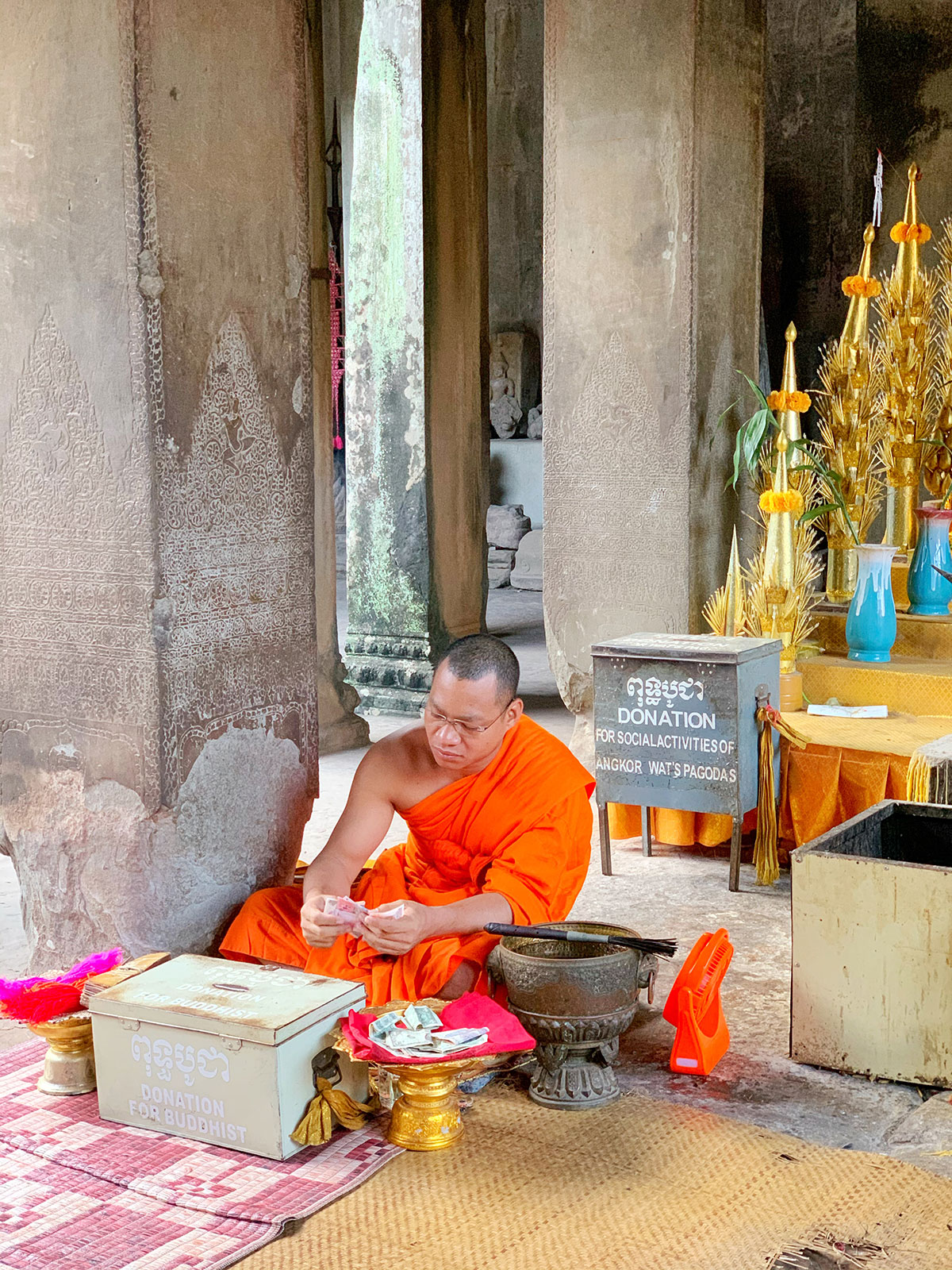 Buddhist monk counting money Angkor Wat