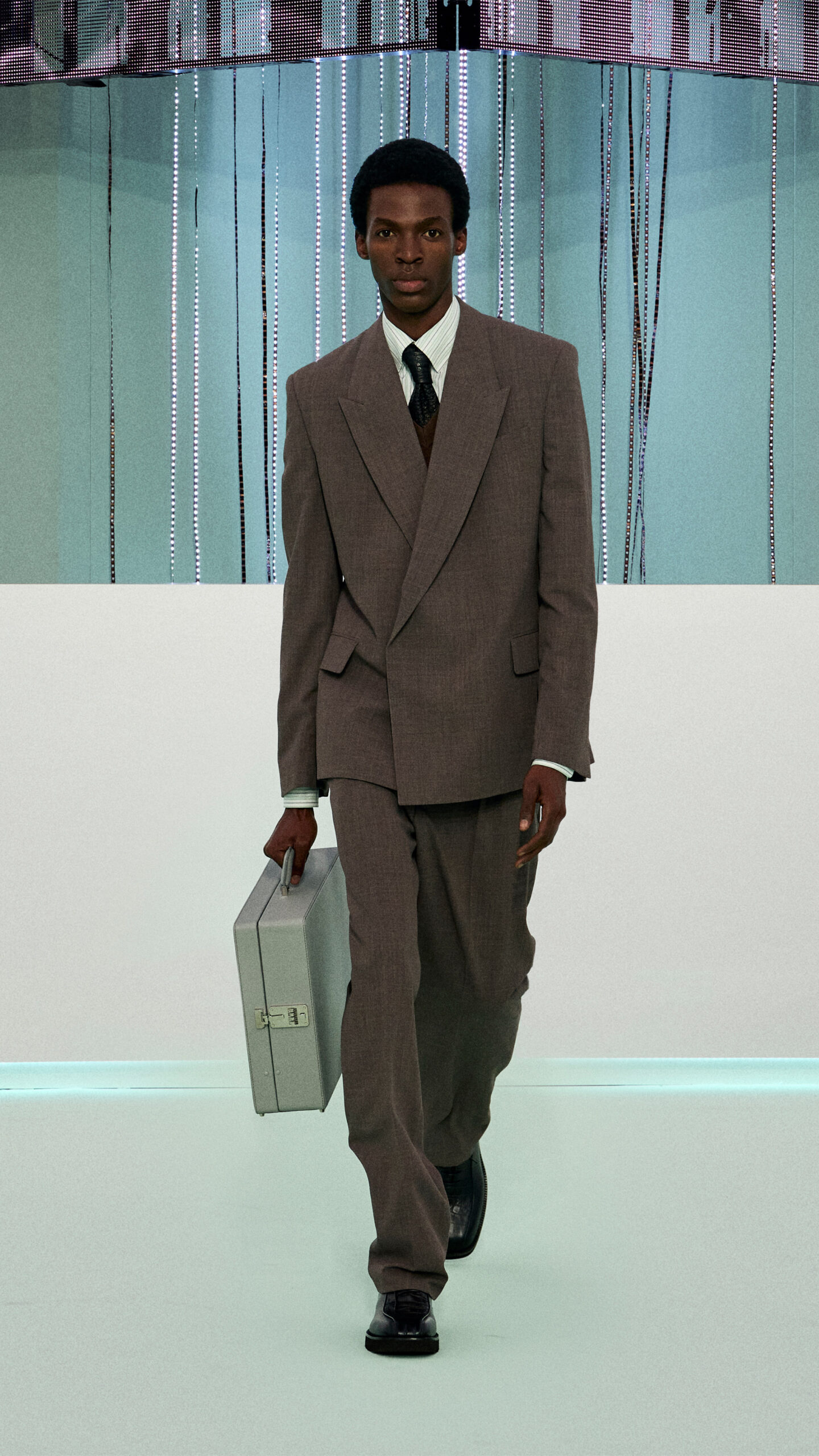 Model wearing suit walking down runway of HUGO BOSS Fall Winter 2023