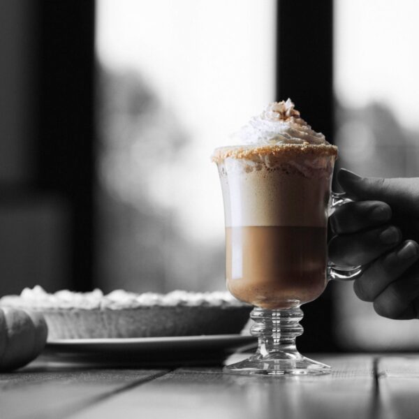Five Farms Irish Cream Liqueur Pumpkin Pie Latte on table with pumpkin and pumpkin pie