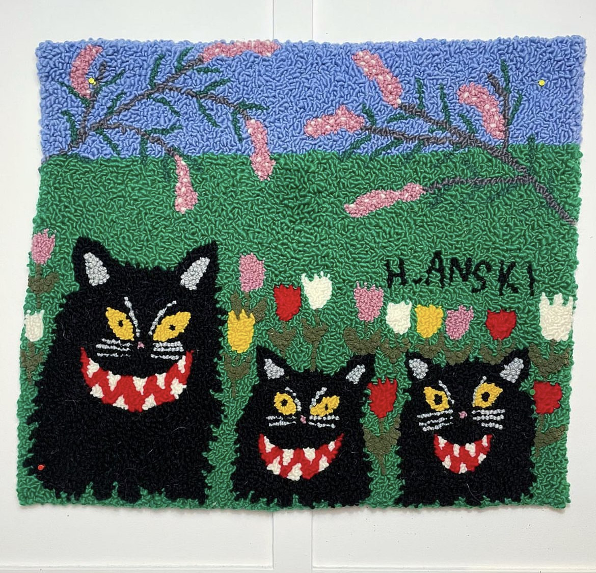 Artist Hanski rug cats in garden