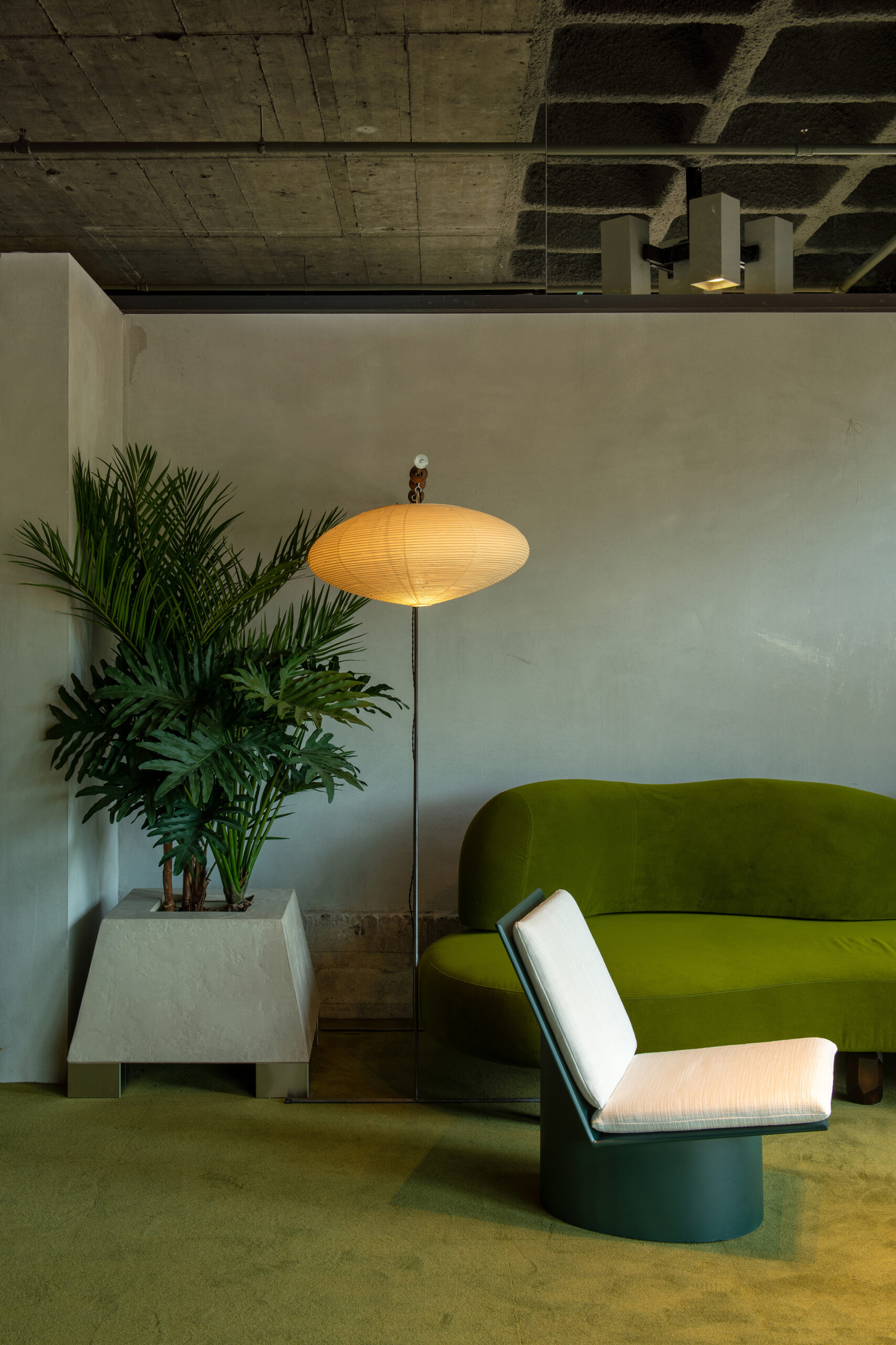 MIX by Brussels Artist Lionel Jadot hotel lounge area with green sofa and floor lamp