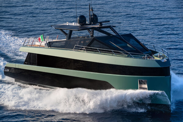 Porto Rotondo yacht green colour driving through ocean during the day