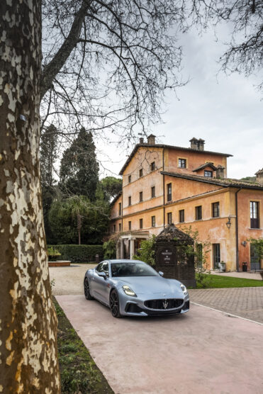 Grey silver Maserati parked next to Italian villa