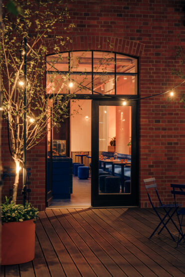 Pastry Club entrance at night with lights