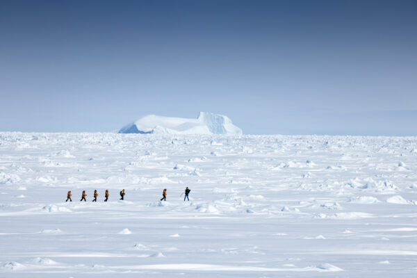 People walking on ice and snow in Greenland