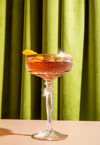 Cocktail with green curtain background
