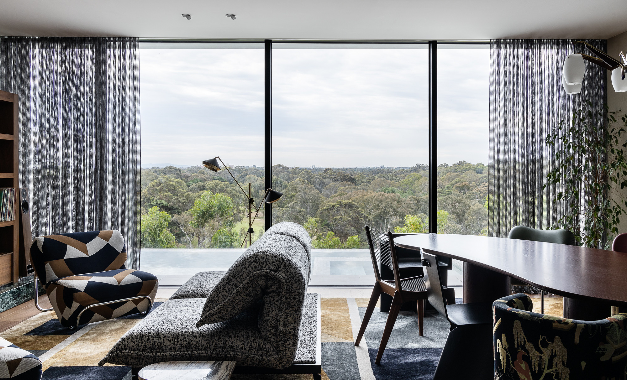 Living room area with dining table overlooking Yarra River Australia